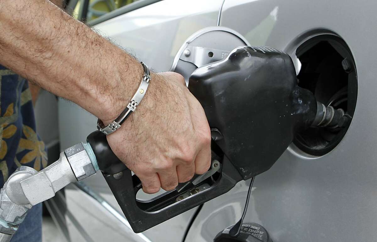 A customer fills up his tank at a local gas station in Miami, Friday, May 27, 2011. With gas prices still topping the $4-a-gallon mark in much of the country and forcing holiday travelers to spend more on fill-ups this Memorial Day weekend, some are opting to to stay closer to home.