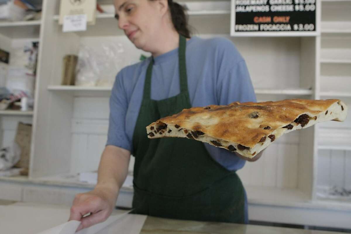 Mary Sorracco prepares to wrap up a piece of raisin focaccia for a customer at Liguria Bakery in San Francisco Calif. on Thursday, June 9, 2011. Sorracco and her brothers are part of the third generation to work and run the bakery, which is celebrating 100 years of bread-making this year.