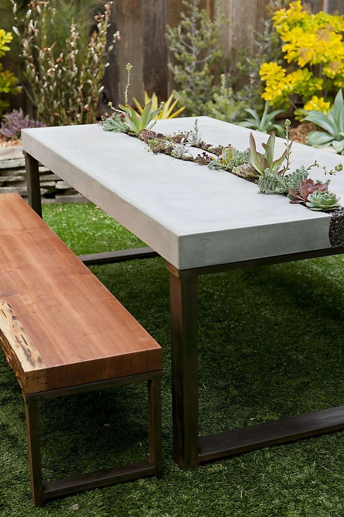 Concrete succulent table. Five Feet from the Moon¡¦s elegant table features a living centerpiece and redwood benches made from a fallen tree. $6,000, including plants, $8,000 with redwood benches. www.fivefeet?’©fromthemoon.com