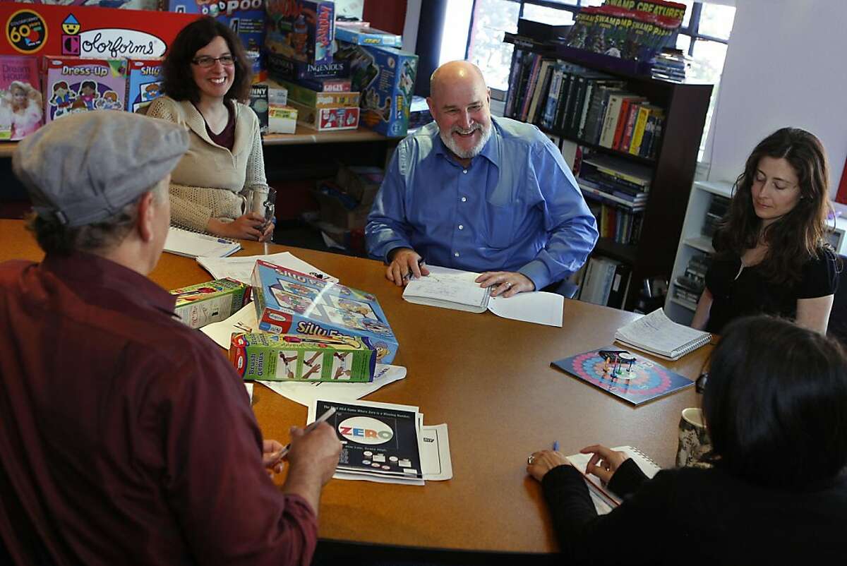 Founder Robert Moog (back, far left) having a staff meeting at University Games in San Francisco, Calif., with vice president of the product department Elise Gresch, vice president of marketing Steve Peek, and product manager Maria Llull as they talk about their newest board game--Zero on Wednesday, May 18, 2011. They also have a lot of colorforms games from the 60s, 70s and 80s, as well as being the largest manufacturer of glow-in-the-dark stars.