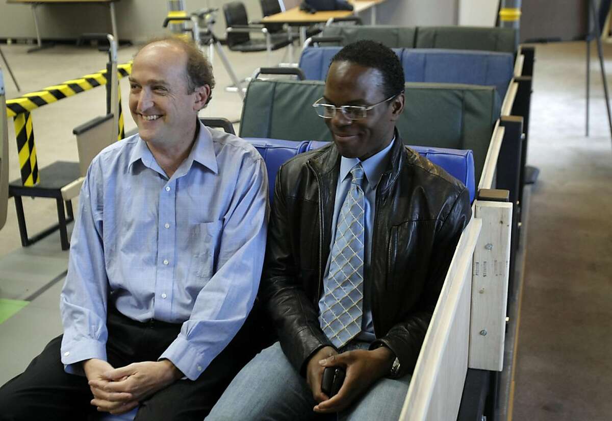 BART Board of Directors President Bob Franklin (left) and spokesman Linton Johnson try potential new BART train seats during a media preview of the mobile seating lab at Joseph Bort Metrocenter in Oakland on Sunday, April 24.