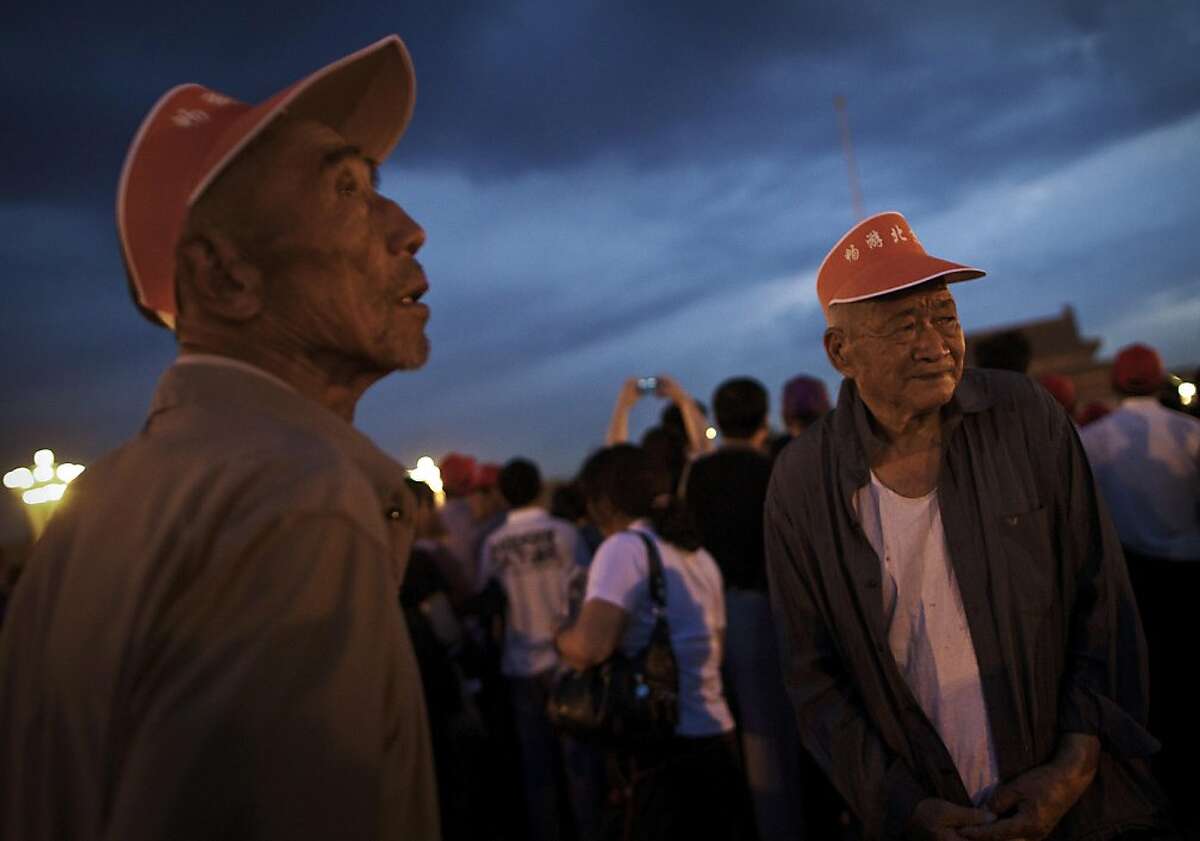 Elderly Chinese wait in the dawn for the flag raising ceremony at the Tiananmen Square in Beijing, China Saturday, June 4, 2011. June 4 marked the anniversary of the deadly 1989 crackdown on pro-democracy protestors in Beijing.