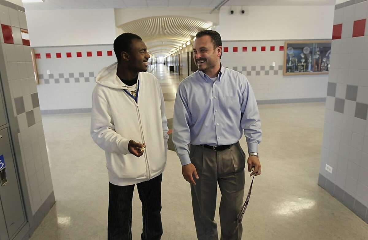 Evander Williams walks the halls of his old school with principal, Guillermo Morales on Thursday June 2, 2011. Williams, a recent graduate of Thurgood Marshall High School in San Francisco, Ca., faced street violence, the murder of friends, bullying and more. He credits his success to the Thurgood Marshall Wellness Program which gave him advice and guidance through his school years and is now set to move onto college.