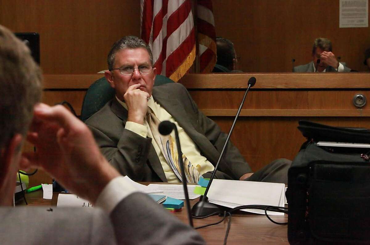 Board of Parole Hearings Commissioner John Peck (center) listens to Ken Karan (left and right reflected in window of observation room), attorney for Steven Martinez (not shown), during the medical parole hearing for Steven Martinez at Corcoran State Prison in Corcoran, Calif., Tuesday, May 24, 2011. Martinez was the first inmate considered for release under the state's new medical parole law. He was denied medical parole.