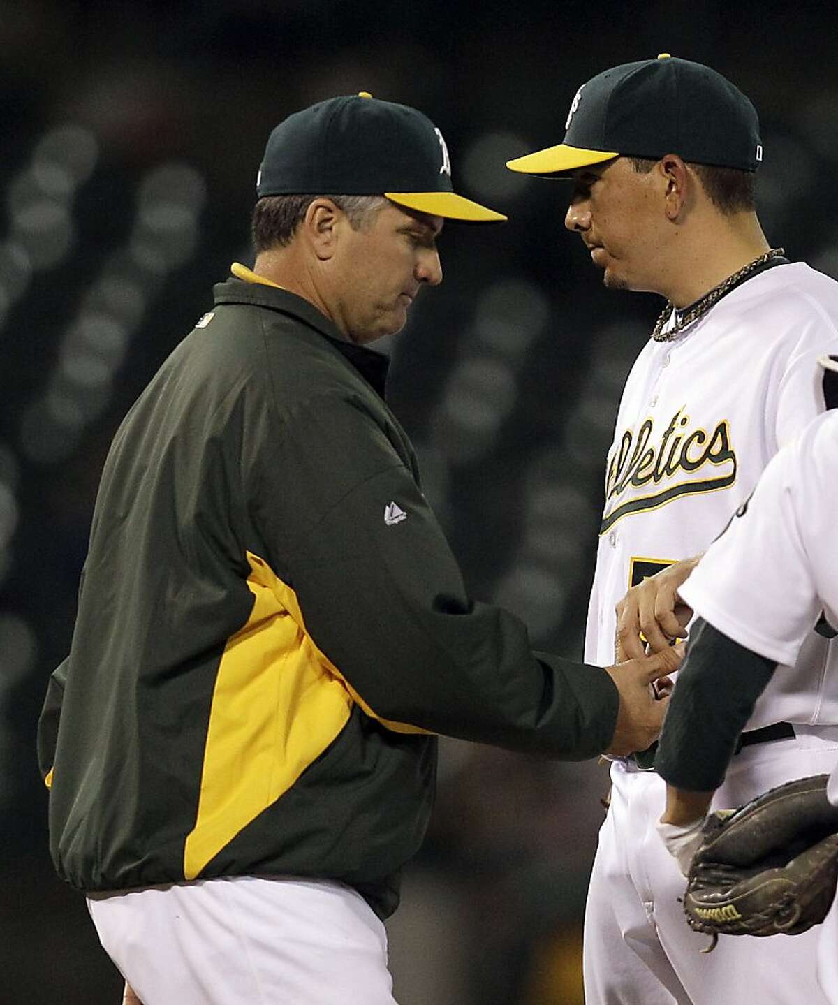 Oakland Athletics manager Bob Geren, left, takes the ball from pitcher Brian Fuentes during the ninth inning of a baseball game Tuesday, May 3, 2011, in Oakland, Calif.