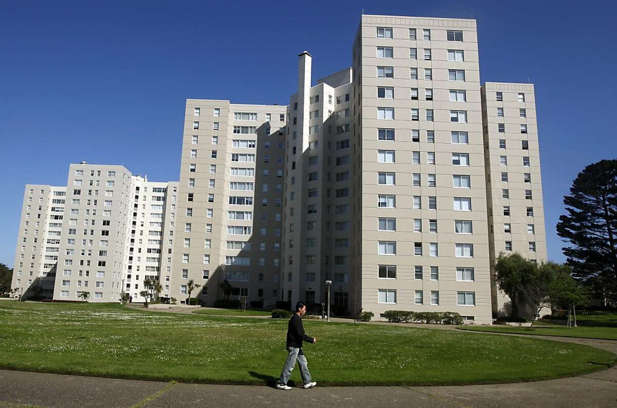 A resident walks through the grounds of the Park Merced neighborhood in San Francisco, Calif., on Thursday, June 10, 2010. Owners of the sprawling complex of houses and high-rise apartment buildings plan to proceed with a $1.2 billion renovation project despite defaulting on their mortgage.