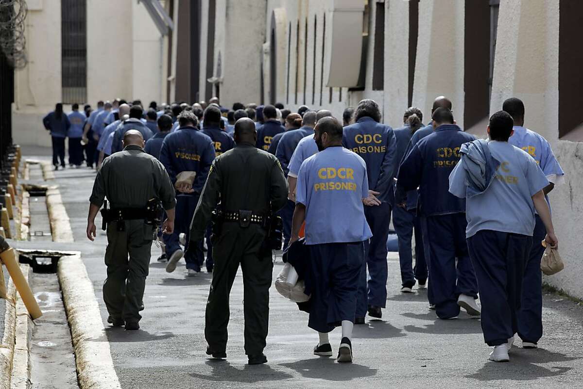 Corrections officers, lead prisoners back to their housing inside San Quentin State Prison, on Friday Mar. 4, 2011, in San Quentin, Ca. California State prison guards and their supervisors, have racked up an astounding 33 million hours of vacation, sick and other paid time off, which could amount to as much as a $1 billion liability for the state. A Senate report warned, a year ago, that mandatory furloughs at a 24-7 agency, would lead to such future burdens.