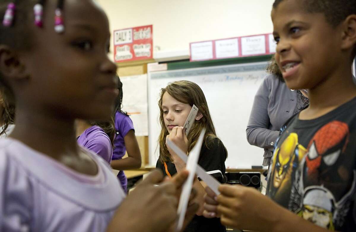 Loren Howard, Neely Odom and Joseph DuBose (left to right) participate in a lesson on gender diversity at Redwood Heights Elementary School in Oakland, Calif. on Monday, May 23, 2011. The students were given cards describing gender differences in nature and then asked to read the cards aloud for the class.