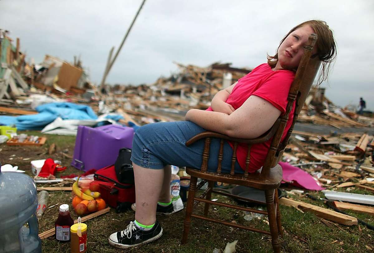 Tornado victims pick up pieces, await new storm