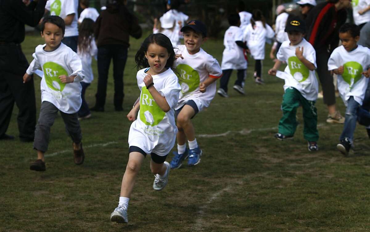 Kindergartners run around in circles at Coleman Elementary School to raise money for school libraries in San Rafael, Calif. on Friday, May 20, 2011. Students throughout the school district gathered pledges per lap run in the fundraising campaign.