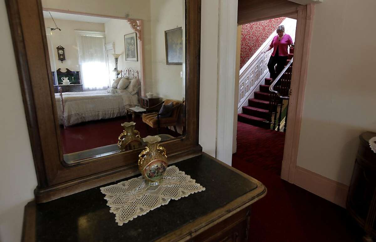 Realtor, Karrie Camerzon walks the stairs near one of the many rooms at the Burlington Hotel in Port Costa, Ca., on Thursday May 12, 2011. The hotel which was originally built in 1883 is currently up for sale.