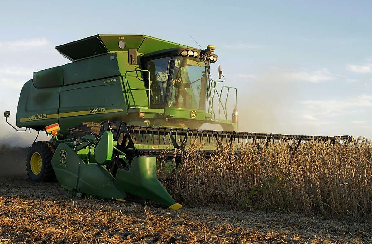 In this photo taken Sept. 30, 2010, central Illinois farmer Steve Dudley races against a setting sun to harvest soybeans in Pleasant Plains, Ill. Farm equipment maker Deere & Co. reversed a loss in last year's fiscal fourth quarter to report a $457.2 million profit Wednesday, Nov. 24, as conditions improved on U.S. farms.