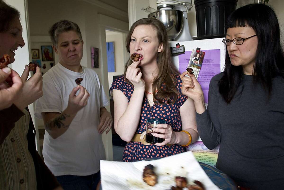 Nicki Green, Ali Liebegott, Kelly Zehnder and April Kim (left to right) taste rumaki made with human placenta during a meeting of the SF Food Adventure Club where the challenge was to eat human placenta at club founder Beth Pickens' apartment in San Francisco, Calif., on Sunday, March 13, 2011.