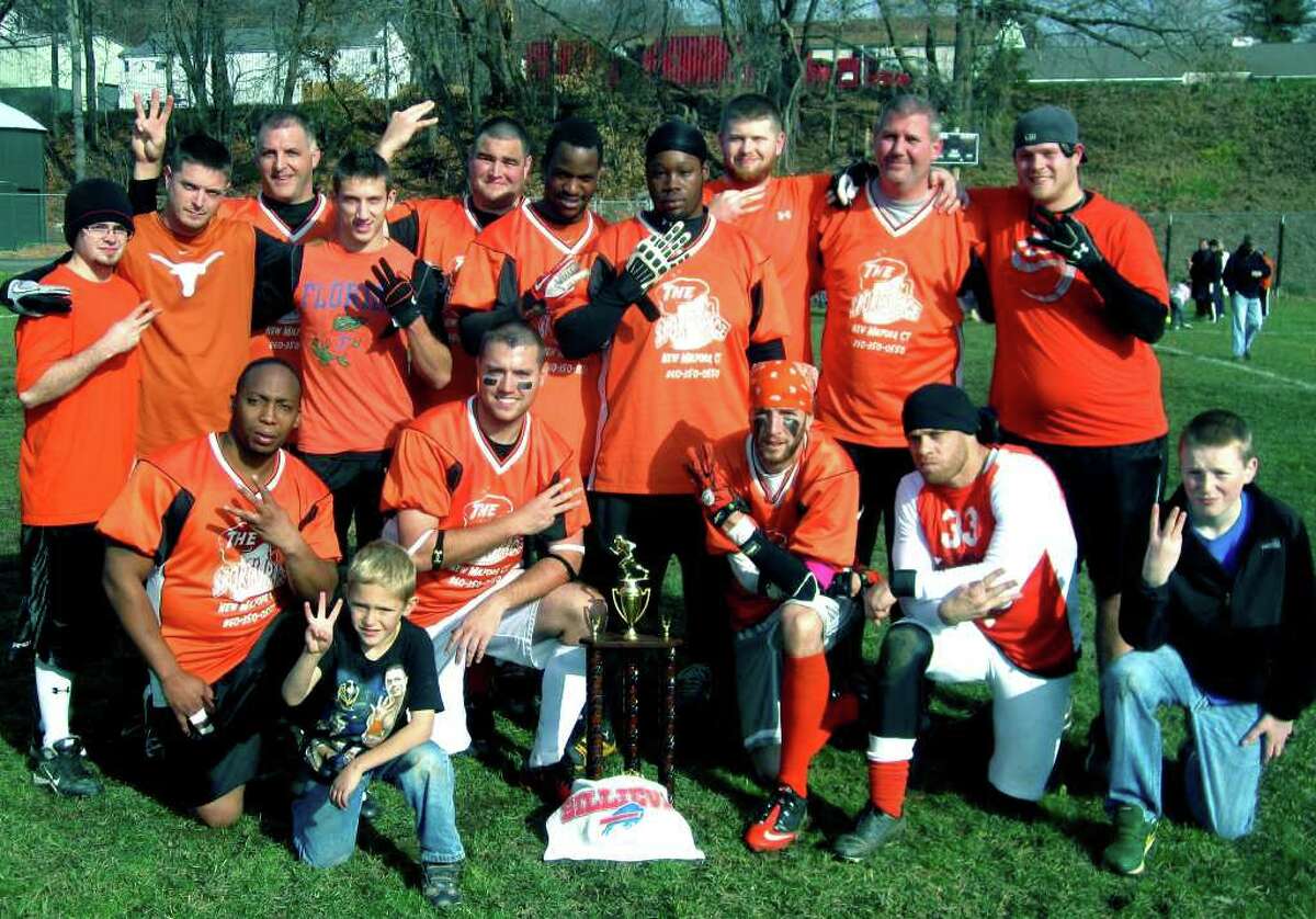 SPECTRUM/Players from the title-winning Sports Page Cafe hold up three fingers apiece Sunday to signify the stooltoppers' third straight championship in the New Milford Parks & Recreation men's touch football league. Celebrating the team's success at Young's Field are, Matt McCauley, son of player Matt McCauley, alongside the trophy; from left to right, front row, Darrel Brown, Dan McCauley, Matt McCauley, Tony Morales and Connor Douskey, son of player Mike Douskey; middle row, Curtis Stapleton, Nick Cox, Donald Clady, Delton Joe and Rey Roman III; back row, Greg Giroux, Ryan Kehoe, Luke Martin, Mike Douskey and Bryan Hamilton. Nov. 27, 2011