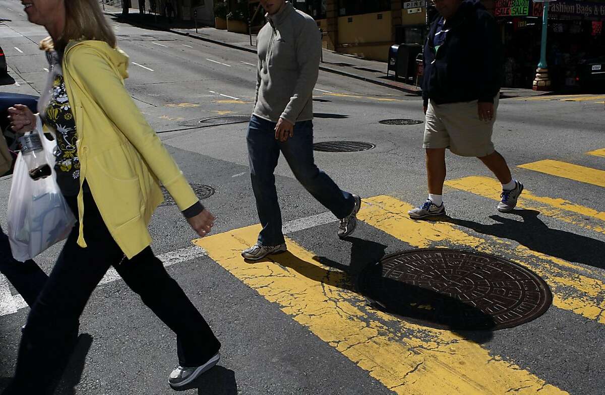 Pedestrians crossing the street on Grant at Pine streets in San Francisco, Calif., on Friday, May 12, 2011.