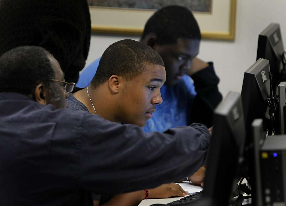 Berkeley Tech students Elliott Spillard (center) and Anthony Johnson (right) search for records on their ancestry in the Family History Center at the Mormon Temple in Oakland, Calif. on Thursday, May 12, 2011.
