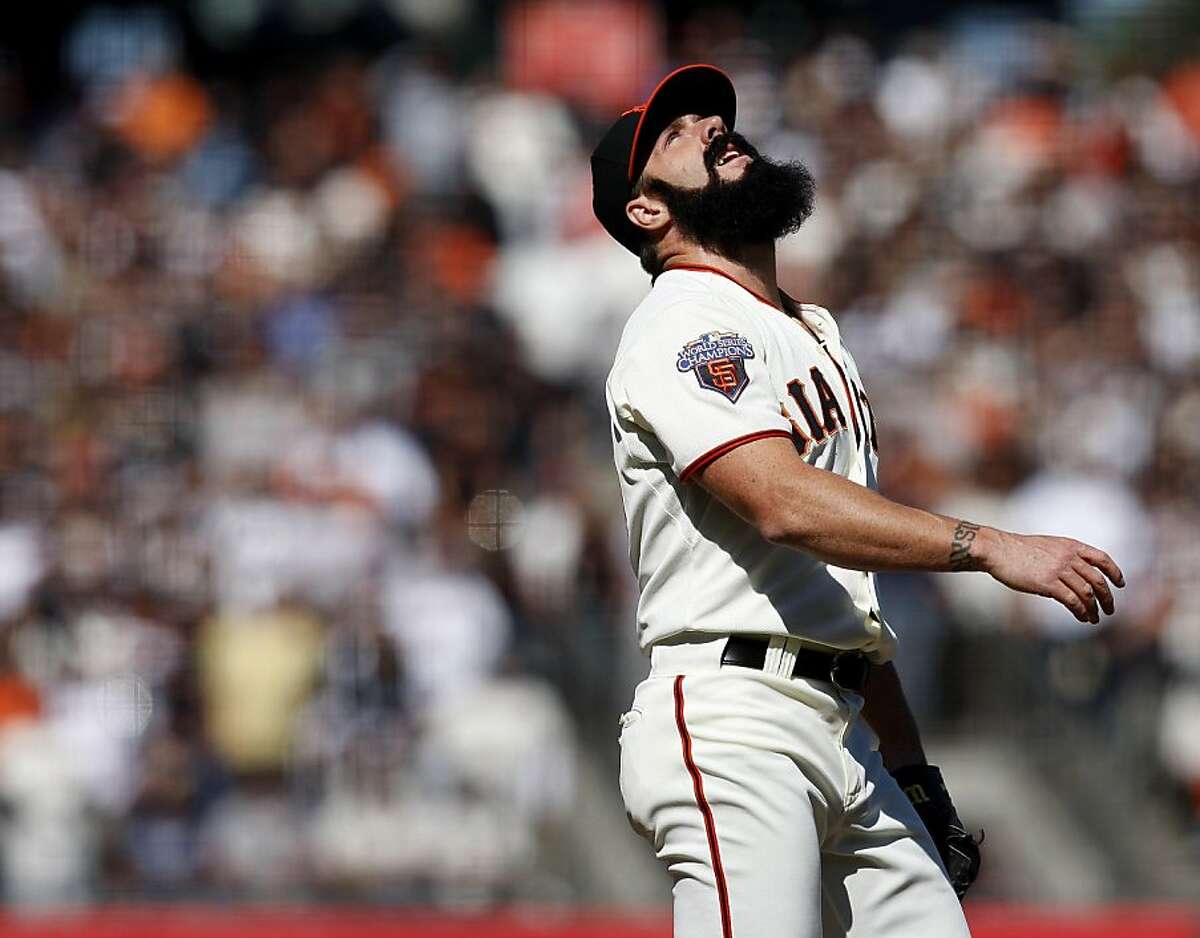 Giants closer Brian Wilson watches a foul ball go into the stands in the 10th inning against the Atlanta Braves on Sunday.