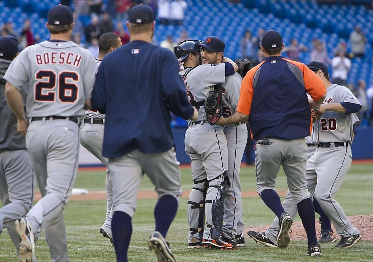 Teammates rush out as Detroit Tigers pitcher Justin Verlander, center right, and catcher Alex Avila celebrate Verlander's no-hitter against the Toronto Blue Jays in a baseball game in Toronto on Saturday, May 7, 2011.