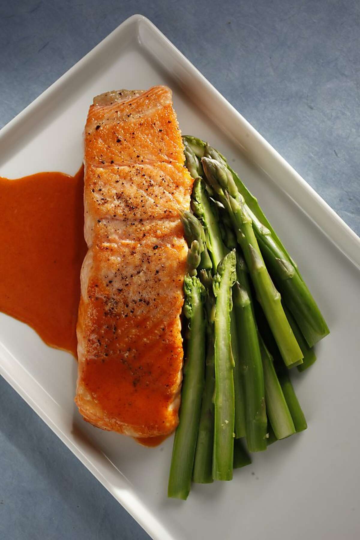 Pan-seared salmon fillet with smokey chili-lime butter sauce as seen in San Francisco, California, on Wednesday April 20, 2011. Food styled by Sophie Brickman.