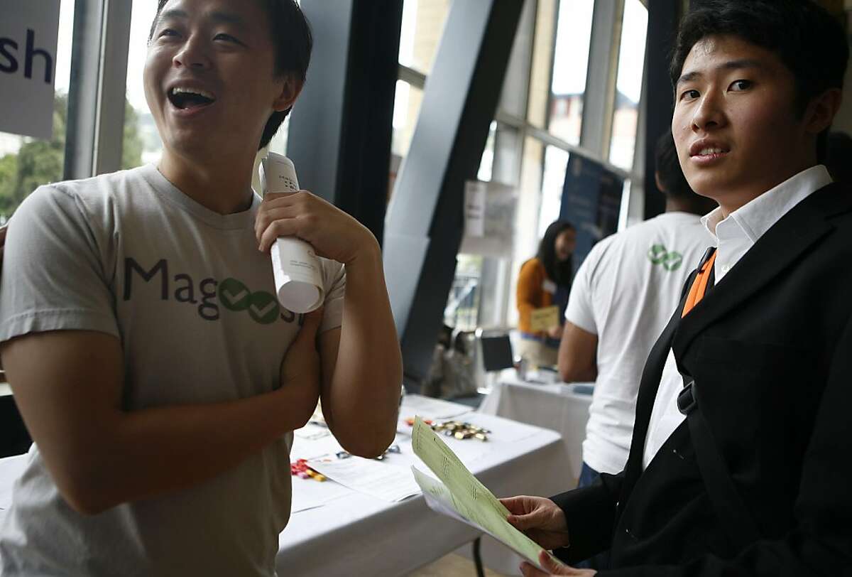 Hansoo Lee (left), a representative of Magoosh, laughs while speaking to Ino Chang (right), a business student looking for a job. The UC Berkeley pre-graduation career fair held on Wednesday, April 20, 2011, attracted 148 potential employers this year, up from 95 last year.