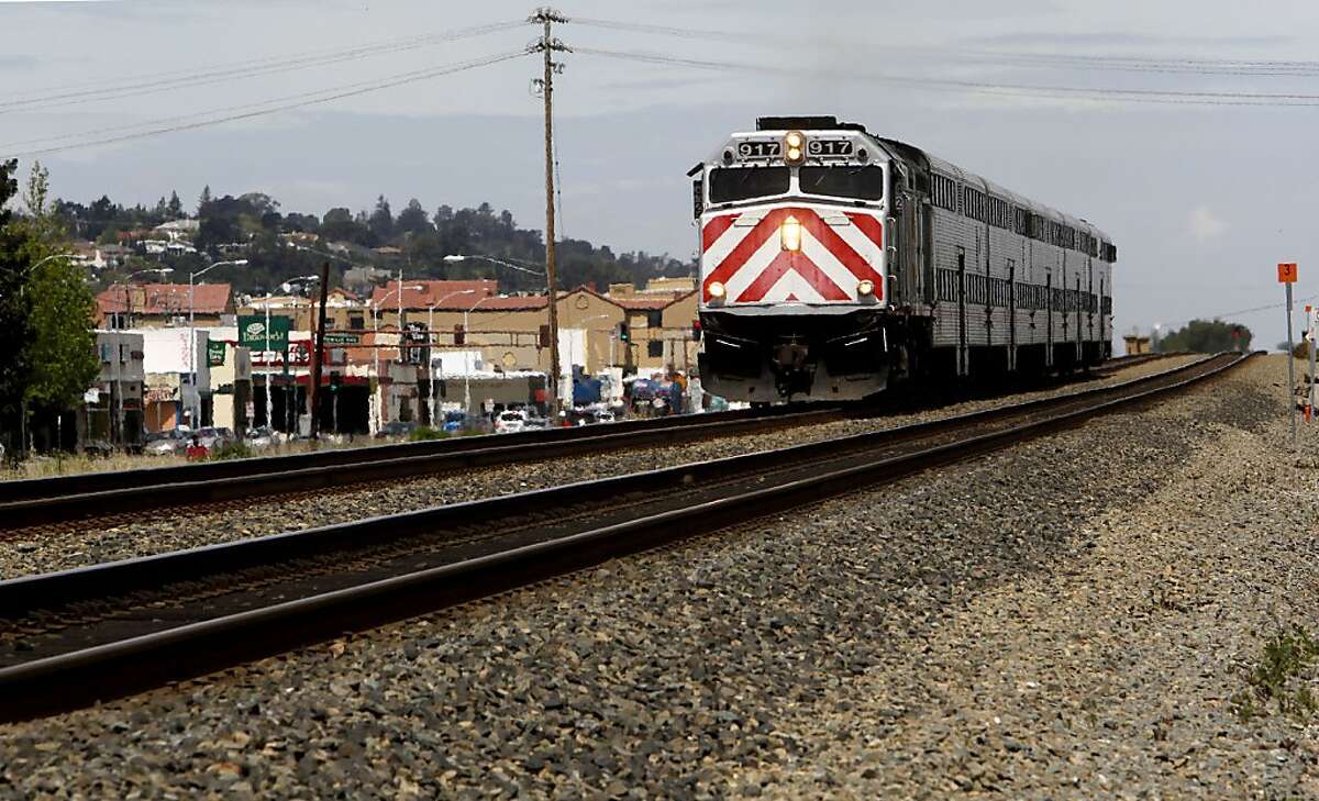 A CalTrain glides along an elevated section of track through San Carlos, Calif. on Wednesday April 29, 2009, as a battle is shaping up on the Peninsula over high-speed rail service through the Peninsula with residents and cities favoring a system that runs through a tunnel or along a sunken trench.
