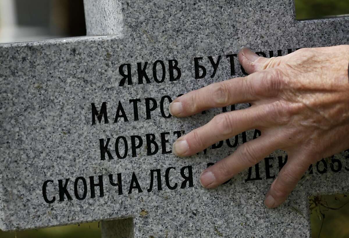 Kenneth Zadwick rubs the lettering indentations on the new granite gravestone of a Russian sailor Thursday April 14, 2011. Kenneth Zadwick helps care for the Mare Island Cemetery in Vallejo, Calif. as part of his role as head of the Mare Island Park Historical Foundation.