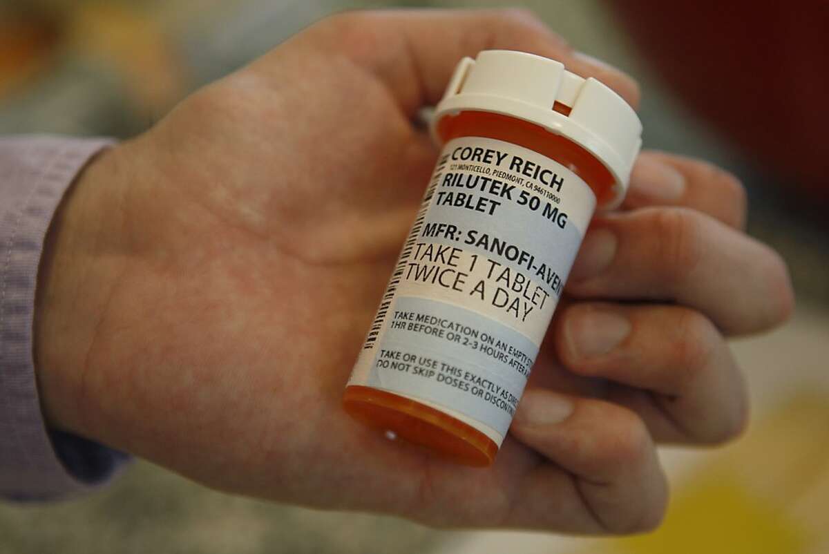 Corey Reich holds a bottle of prescription medication at his home in Piedmont Calif, on Thursday, March 24, 2011. Although he takes the pills twice a day, he does not expect them to prolong his life longer than a month or so, but takes them because the expected side effects are considered mild.