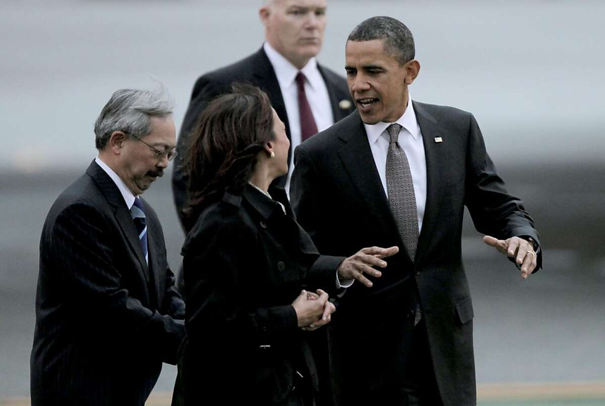 President Barack Obama walks with State Attorney General Kamala Harris and San Francisco Mayor Ed Lee upon his arrival aboard Air Force One, at San Francisco International airport, on Thursday Feb. 17, 2011, for a one day visit with local business leaders in the fields of technology and innovation.