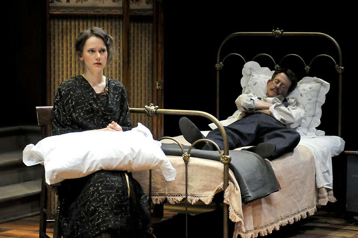 Masha (Natalia Payne) broods while her husband Kulygin (Keith Reddin) sleeps in Chekhov's "Three Sisters" at Berkeley Repertory Theatre