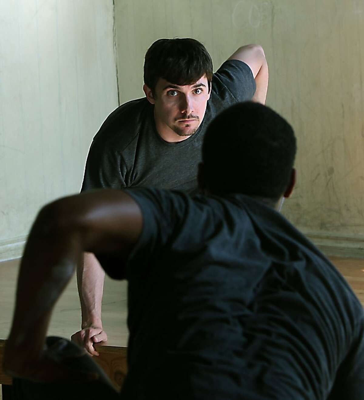 Sean Grimm (top) and Matthew Wickett (front) during a dress rehearsal of "The Monkey and the Devil." a production that traces contemporary racism with roots in America's slave trade in San Francisco, Calif., on Monday, April 11, 2011.