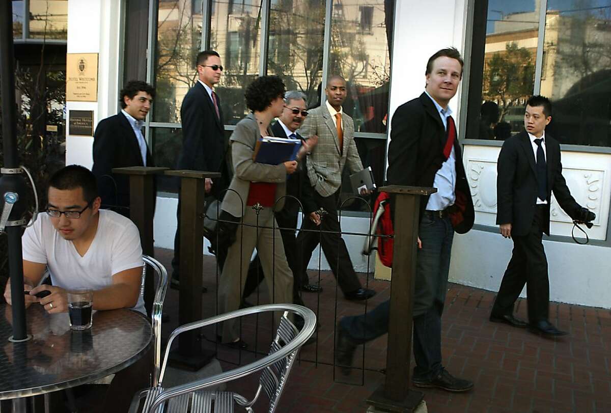 Sean Garrett (second to right) of Twitter, is given a tour of the central Market St. area with mayor Ed Lee in San Francisco, Calif., on Wednesday, April 6, 2011. Jeffrey Huynh (left) having a coffee outside of the Market Street Grill.