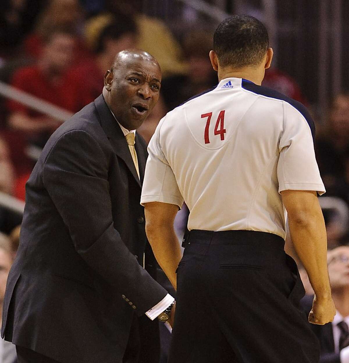 Golden State Warriors head coach Keith Smart, left, disputes a call with referee Curtis Blair (74) during the third quarter of an NBA basketball game against the Houston Rockets, Wednesday, March 23, 2011, in Houston. The Rockets beat the Warriors 131-112.