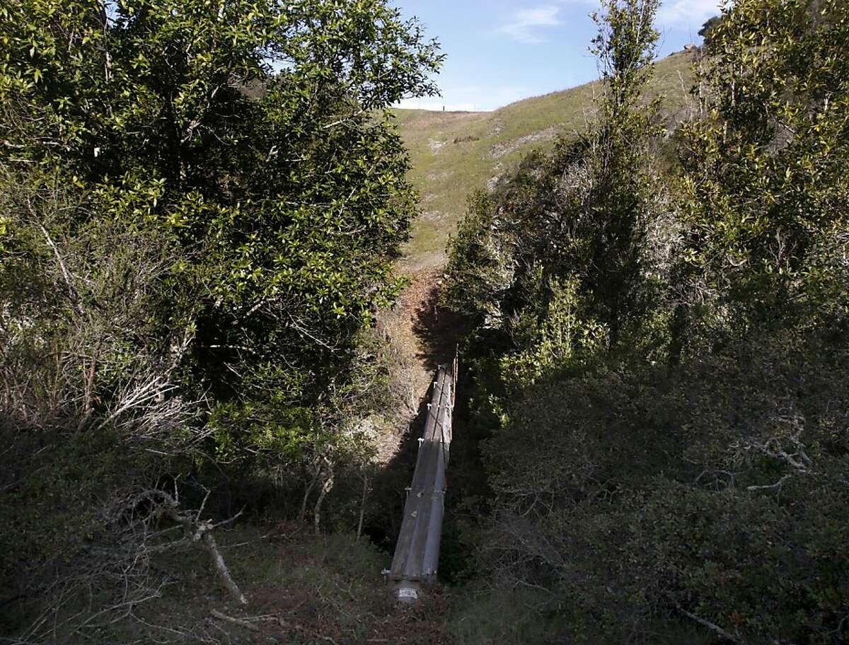 An exposed section of PG&E's Line 109 gas transmission pipeline spans a creek on a steep hillside in Redwood City, Calif. on Friday, April 1, 2011.