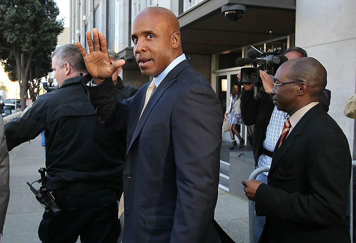 Former Major League Baseball player Barry Bonds waves as he leaves federal court at the end of the day on April 7, 2011 in San Francisco, California. Closing arguments have wrapped up in Bonds' perjury trial as the jury prepares to deliberate.