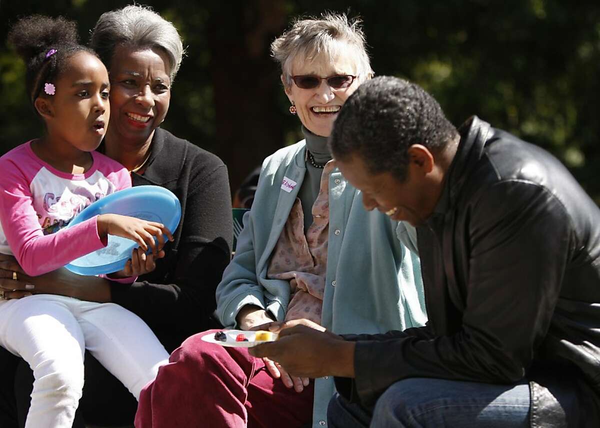 Elisabeth Garst (center) talks with her former student Robert Ramsey (right) and his mother Eleanor Ramsey (left) and Ade Porter (far left), Robert's niece, at a reunion of former students that were in grades K-3 together at John Muir Elementary School in Berkeley, Calif., on Sunday, April 10, 2011.
