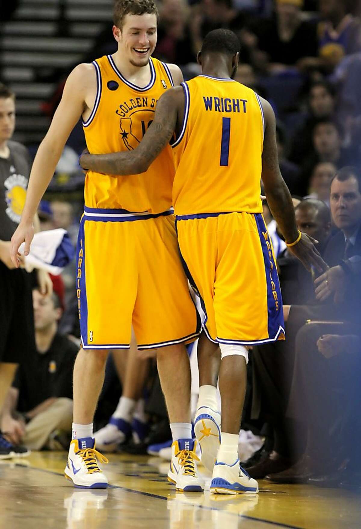 Dorrell Wright, right, gets a hug from teammate, David Lee after Wright came out of the game in the final minutes. The Golden State Warriors played the New Orleans Hornets at Oracle Arena in Oakland, Calif., on Tuesday, February 15, 2011.