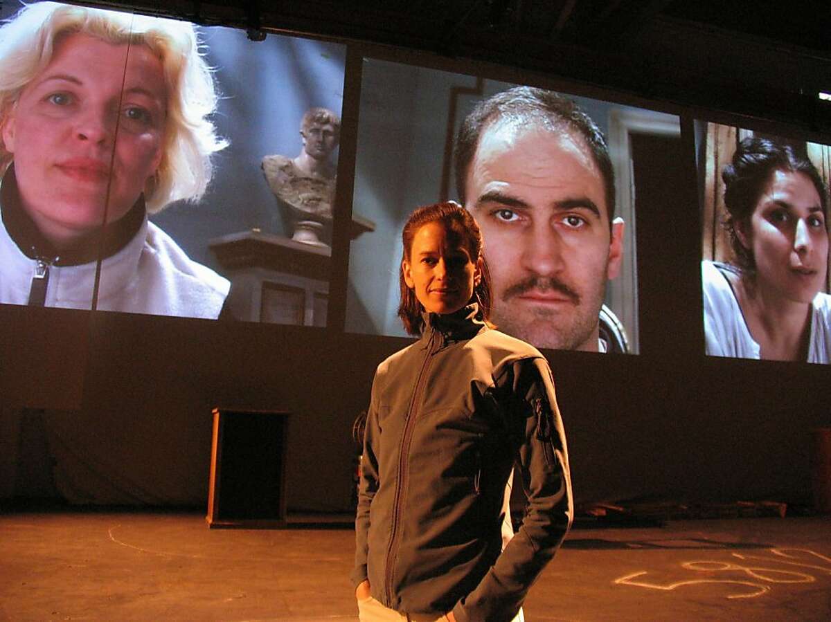 During a rehearsal, director Kim Collier stands on the "No Exit" set, with the cast (from left: Lucia Frangione, Andy Thompson and Laara Sadiq) projected on screens behind her. "No Exit" is part of the American Conservatory Theater season. Photo by Nathan Medd.