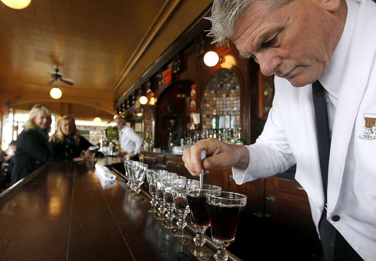 Bartender Paul Nolan mixes two sugar cubes with black coffee before adding Irish whiskey and cream for a world famous Irish coffee drink at the Buena Vista Cafe in San Francisco, Calif. on Saturday, April 2, 2011. The venerable watering hole cornered the market on the original glasses when the manufacturer decided to stop making them. They now have a manufacturer in China but, according to management, aren't quite the same quality.