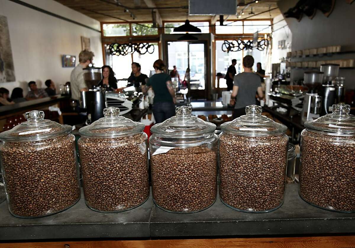 Customers at Four Barrel Coffee have a dizzying assortment of beans to choose from. Popular local coffee roasters like Four Barrel Coffee on Valencia Street in San Francisco, Calif. are raising prices due to decreasing supply and rising production costs. Four Barrel is organizing a forum to explain price increases to its wholesale customers.