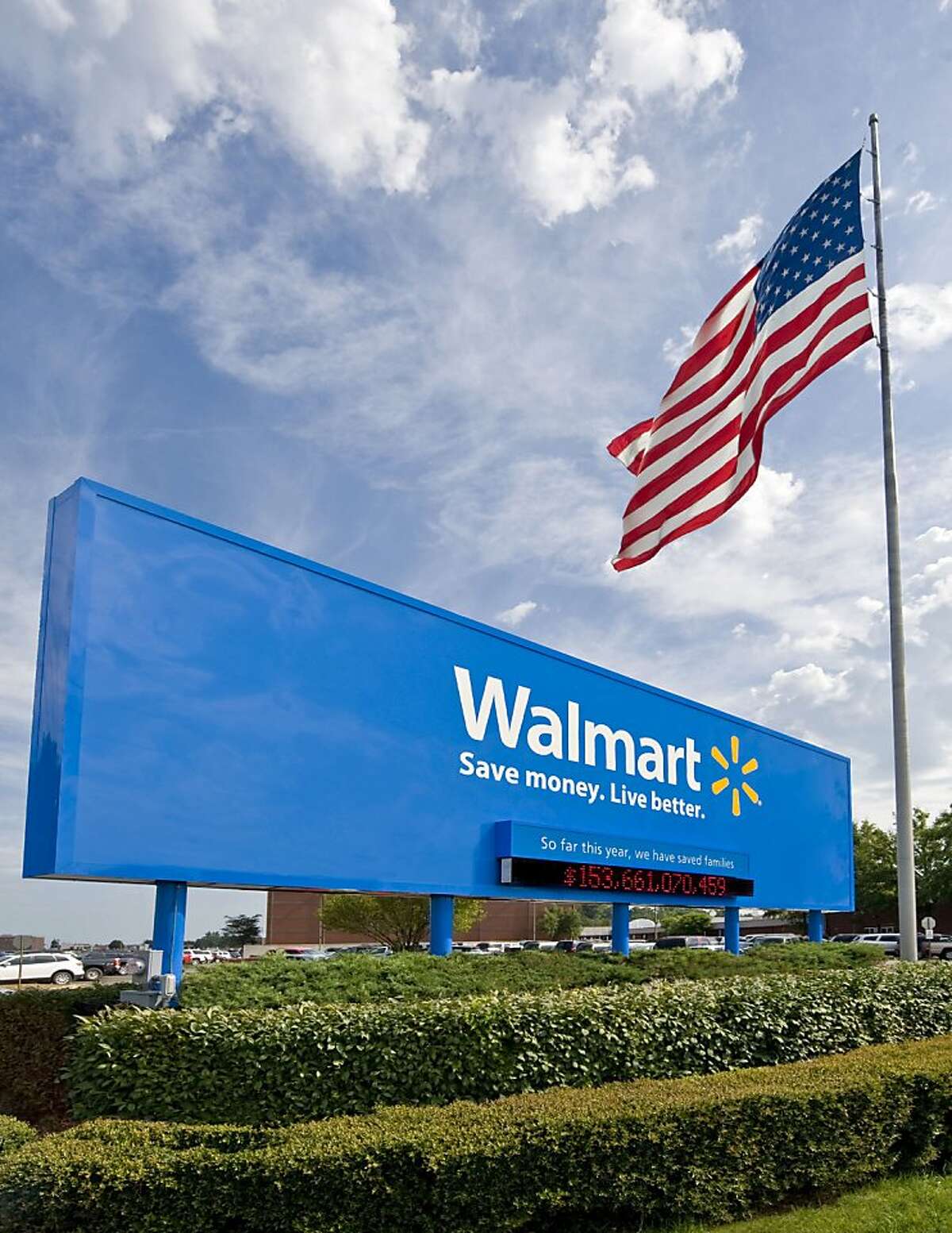 This undated file photo provided by Wal-Mart Stores Inc., shows the company's sign in front of their Bentonville, Ark., headquarters. Wal-Mart Stores Inc. announced a program Thursday, June 3, 2010, in which its workers can receive college credit from the online American Public University and receive a tuition discount from the school.