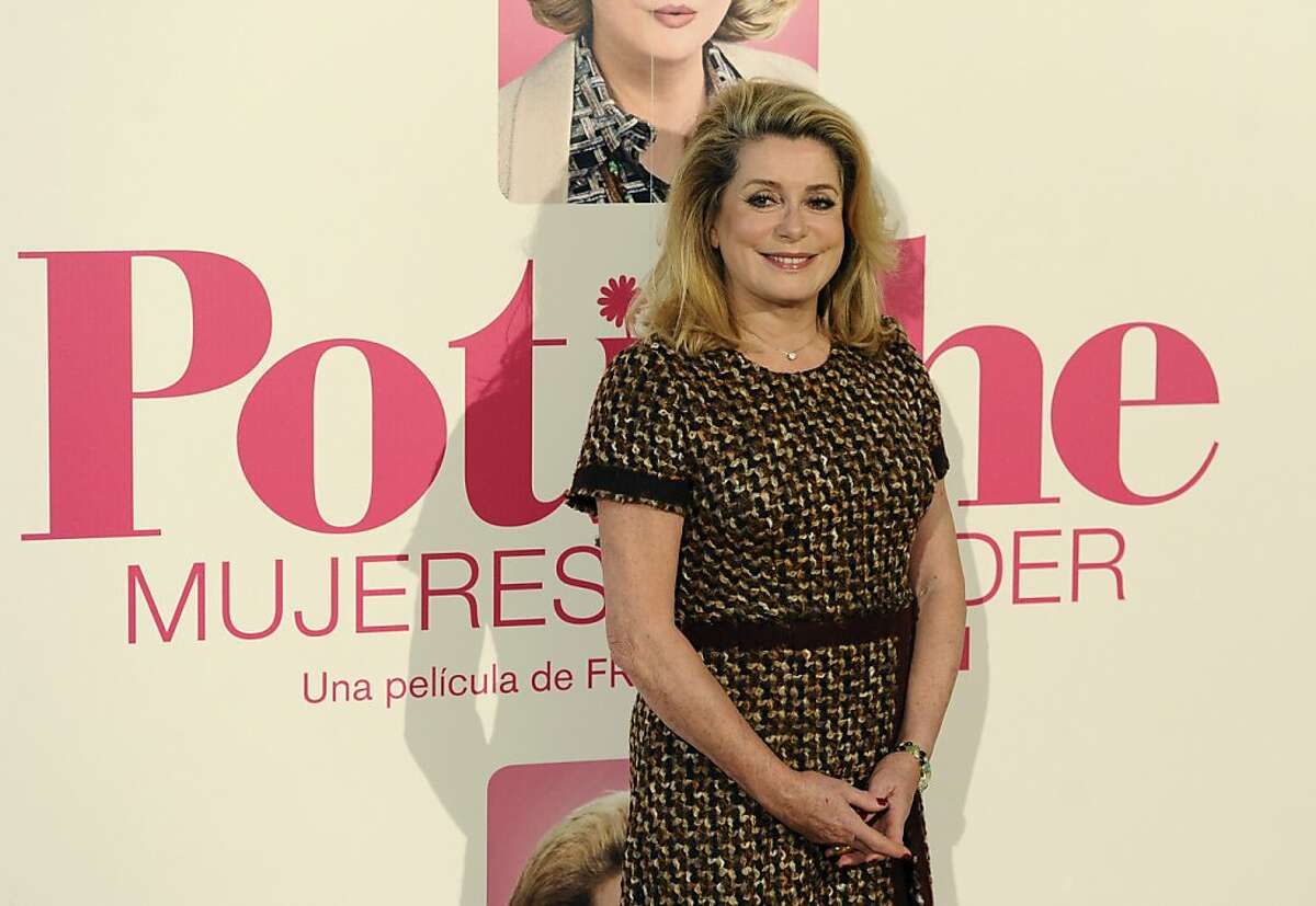 French actress Catherine Deneuve poses during a photocall for the presentation of French director Francois Ozon's movie "Potiche" in Madrid on March 18, 2011. Based on a play of the same name -- which translates with difficulty as "trophy wife" -- the comedy relates the unlikely transformation of bourgeois housewife Suzanne Pujol (Deneuve) into company executive and her complex relationship with a tough-as-nails union leader played by Depardieu.