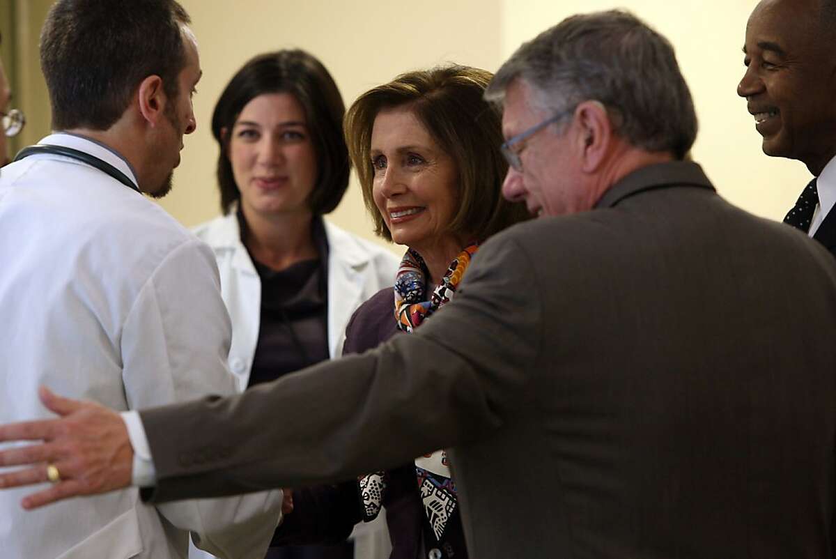 Democratic Leader Nancy Pelosi (middle) being greeted by David Lawn (left), M.D., director of nursing Elizabeth Ewing (middle, left), and chief executive officer Charles Range of the South of Market Health Center in San Francisco, Calif., on Monday, March 28, 2011.