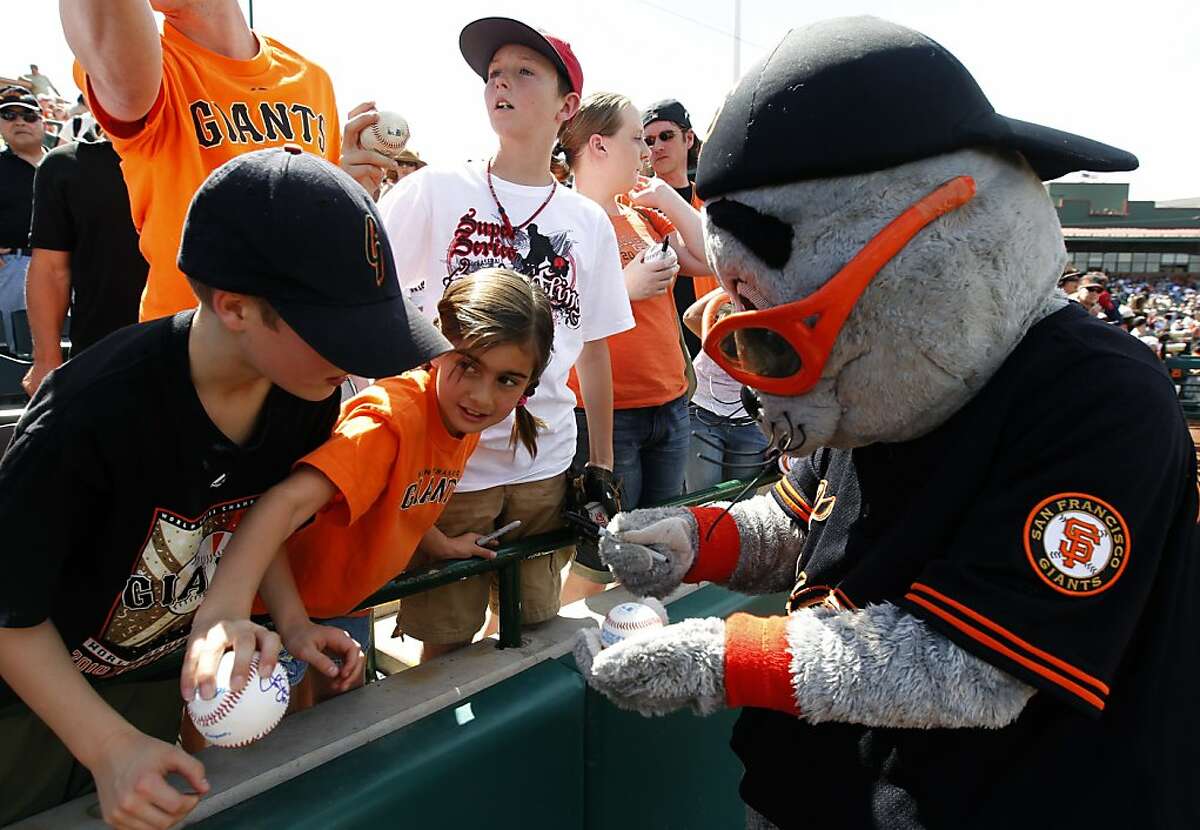 Lou Seal signs asutographs for young fans before the Giants 6-3 loss to the Los Angeles Dodgers in a spring training baseball game at Scottsdale Stadium in Scottsdale, Ariz. on Friday, March 18, 2011.