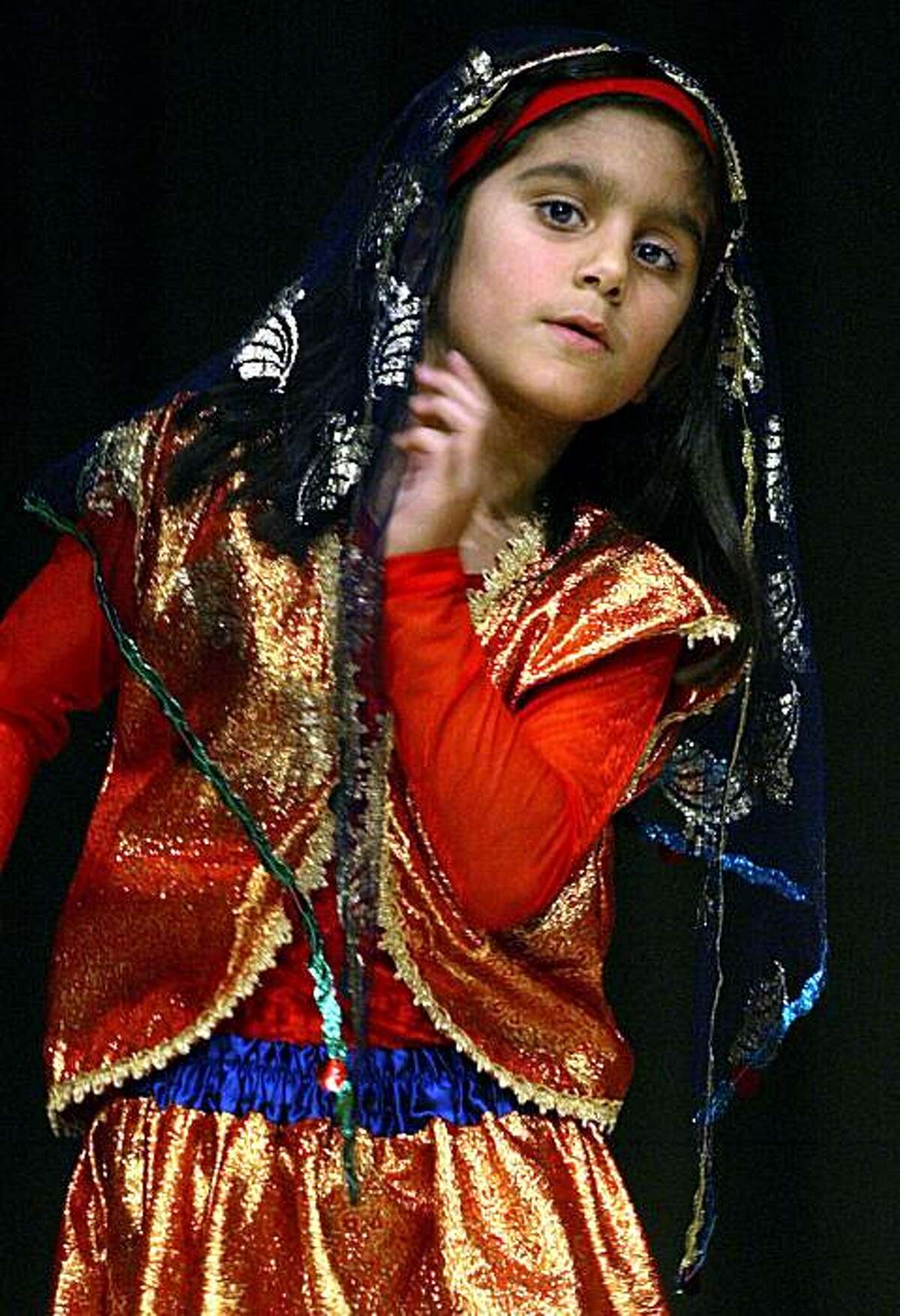 Tara Taeed, 7 years old, from the Shahrzad Dance Academy dances "Aroosak" at the Persian festival taking place at Bentley School. Photo taken on 02/25/04 in Oakland, CA. Photo By LIZ HAFALIA / The San Francisco Chronicle