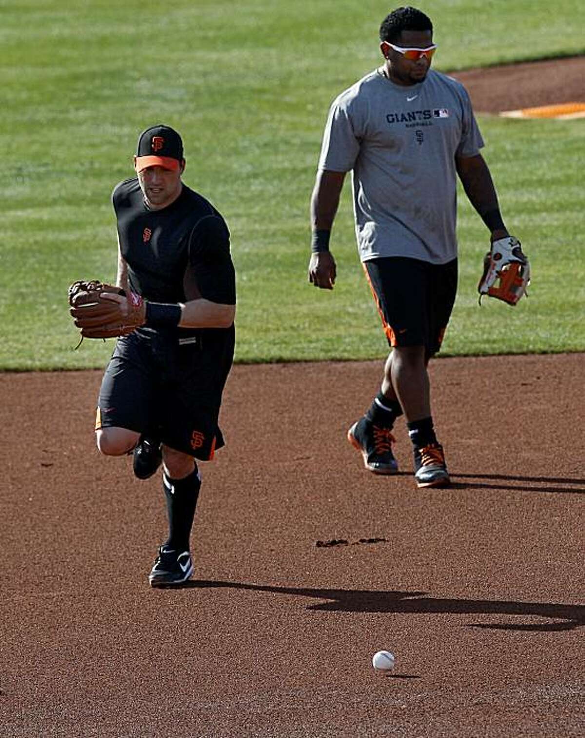 Mark DeRosa (left) and Pablo Sandoval took some grounders at third base. The San Francisco Giants held their second workout of the spring training season at Scottsdale Stadium in Arizona Wednesday February 16, 2011.