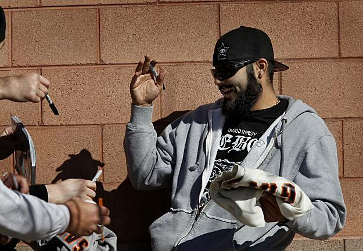 The Giants Sergio Romo celebrated with the fans assembled outside Scottsdale Stadium. The first day of spring training for the 2010 World Champion San Francisco Giants involved mostly pitchers and catchers in Scottsdale, Arizona Monday February 14, 2011.