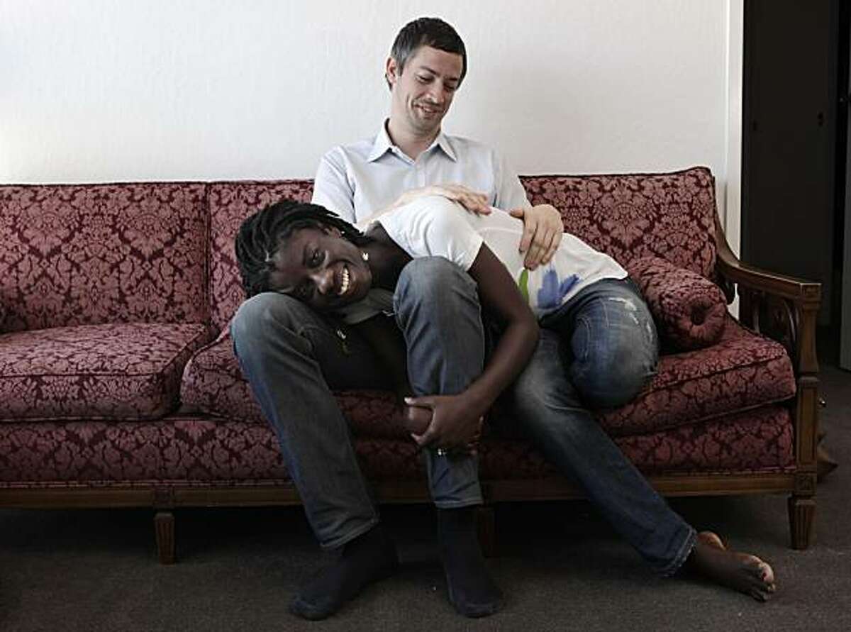 Caleb and Akua Bashor cuddle on their couch at home, Friday May 14, 2010, in San Francisco, Calif. The couple have been together for seven years.