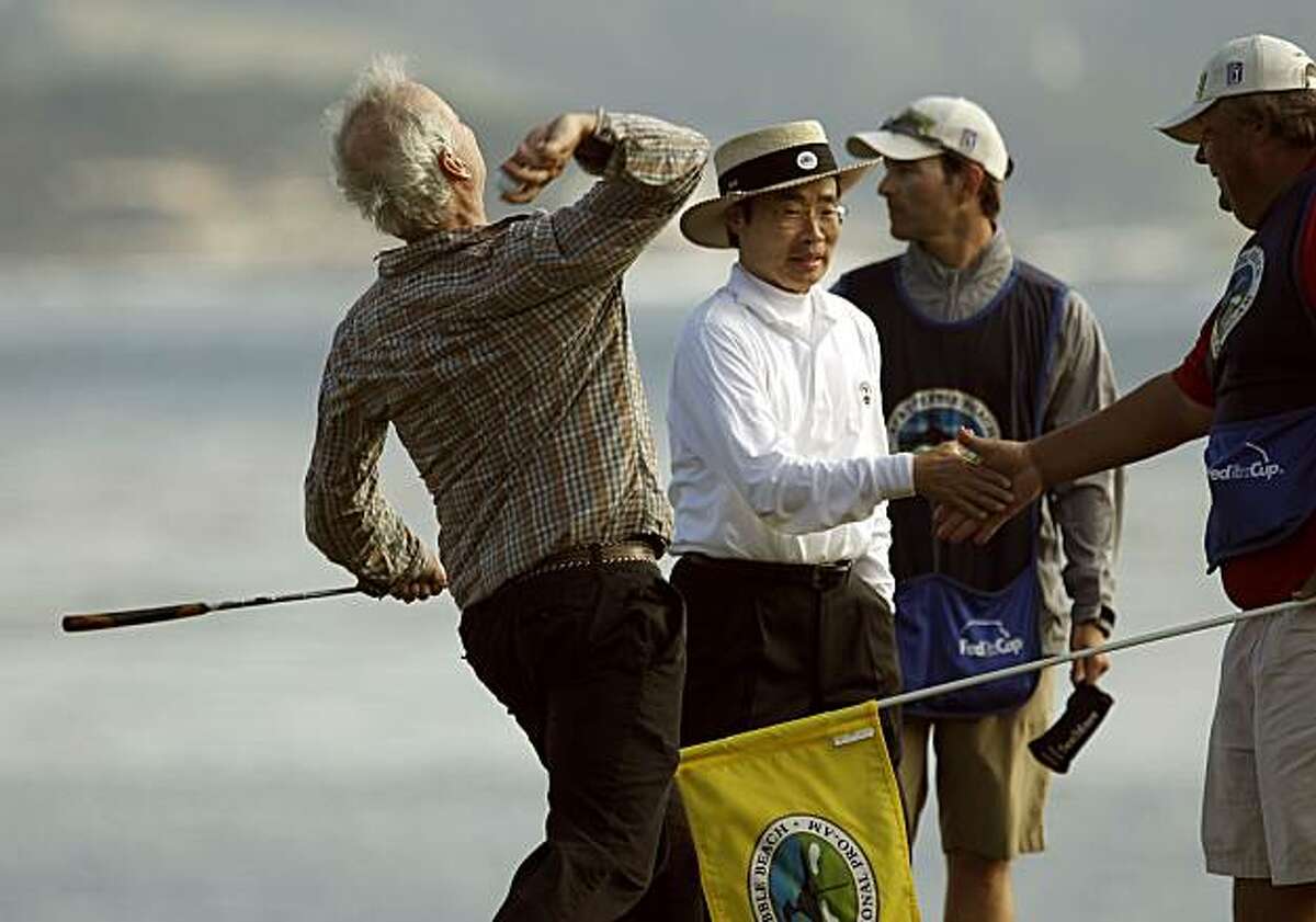 Bill Murray celebrates his amateur win by throwing his ball into the ocean after his final round at the AT&T Pebble Beach National Pro-Am on Sunday.