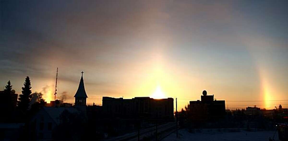 Sun dogs: When the sun's rays pass through ice crystals in the atmosphere, mini-suns can appear at its sides, as in this photo from Fairbanks Alaska, Legend has it that the ancient Greeks figured Zeus was out walking his pooches. Actually, Apollo was the sun god, but who wants to ruin a good story?