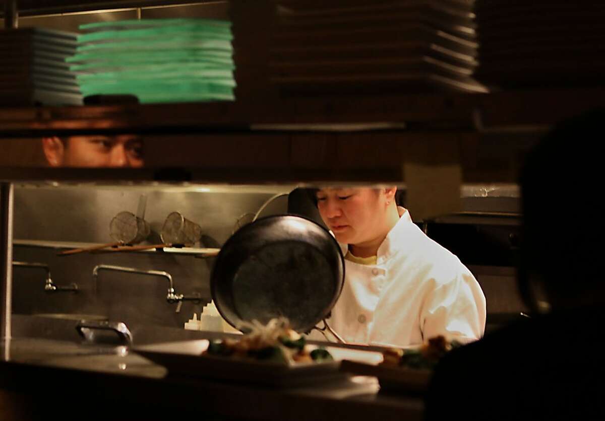 Servers wait as executive chef Beatrice Dong-Edrees prepares a dish in the kitchen at Zadin, a contemporary Vietnamese restaurant, in San Francisco, Calif., on Thursday, March 17, 2011. This was one of the first restaurants in the city to clearly label gluten-free items on its menu.